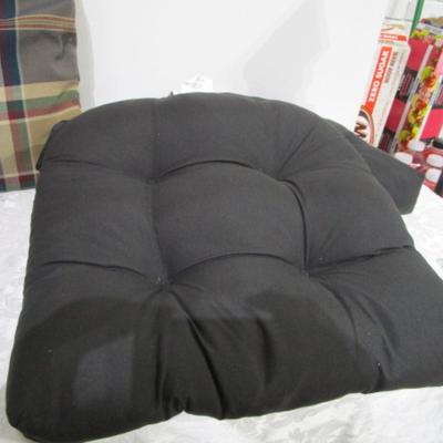 4 black chair cushions, 1 plaid pillow