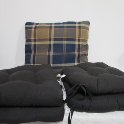 4 black chair cushions, 1 plaid pillow