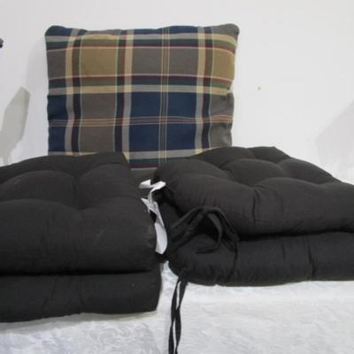 4 black chair cushions, 1 plaid pillow