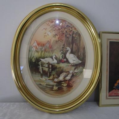 1 oval framed picture of geese near water, 1 framed floral picture