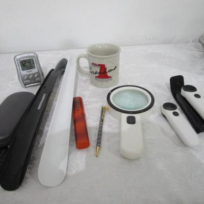 Magnifiers, shoe horns, glasses case, pen, reading glasses, mug, alarm clock