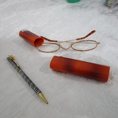 Magnifiers, shoe horns, glasses case, pen, reading glasses, mug, alarm clock