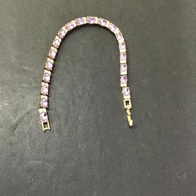 Sale Photo Thumbnail #101: Very nice gold tone purple glass, rhinestone tennis bracelet. Please see attached photos.