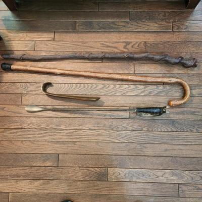 2 Walking Sticks Canes 2 Shoe Horns 1 Very heavy Brass 1 w a Sword handle