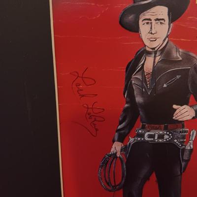 TIN AUTOGRAPHED LASH LARUE SIGN AND A FRAMED VINTAGE ADVERTISEMENT