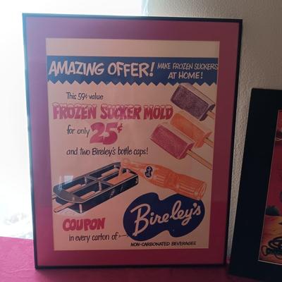 TIN AUTOGRAPHED LASH LARUE SIGN AND A FRAMED VINTAGE ADVERTISEMENT