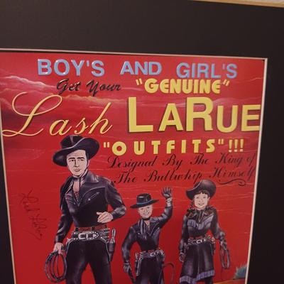 TIN AUTOGRAPHED LASH LARUE SIGN AND A FRAMED VINTAGE ADVERTISEMENT