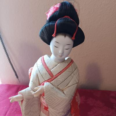 MANY STARS NATIVE AMERICAN THEMED DOLL AND A GEISHA PORCELAIN DOLL