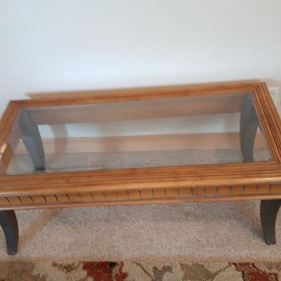 Elegant Glass-Top Coffee Table with Carved Wood Trim