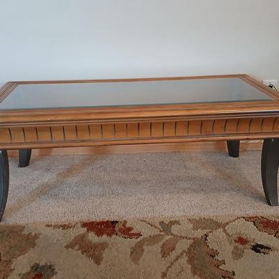 Elegant Glass-Top Coffee Table with Carved Wood Trim