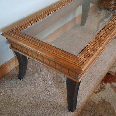 Elegant Glass-Top Coffee Table with Carved Wood Trim