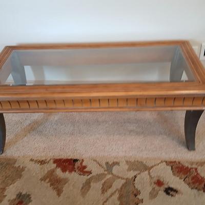 Elegant Glass-Top Coffee Table with Carved Wood Trim