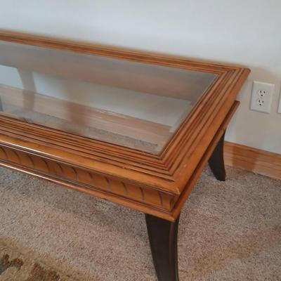 Elegant Glass-Top Coffee Table with Carved Wood Trim