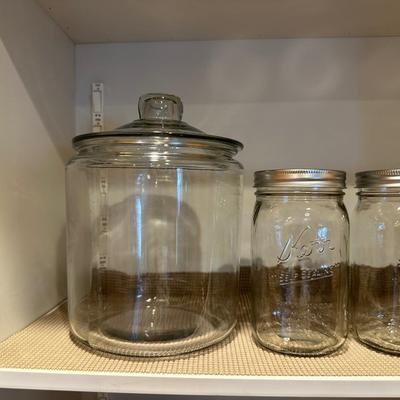 CANNING JARS, MEASURING CUPS AND AN APOTHECARY JAR
