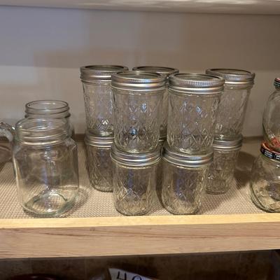 CANNING JARS, MEASURING CUPS AND AN APOTHECARY JAR