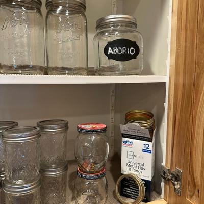CANNING JARS, MEASURING CUPS AND AN APOTHECARY JAR