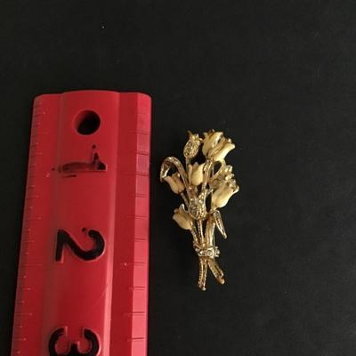 Gold tone brooch with enameled flowers