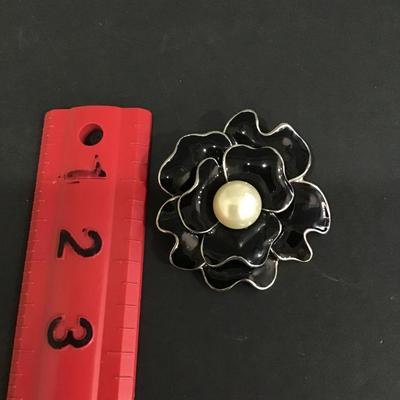 Black enamel flower brooch