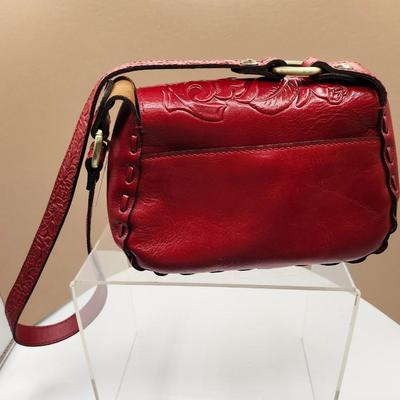 Sale Photo Thumbnail #147: Crossbody, dust bag, one outside pocket, 
tooled berry red, one zippered inside pocket, unique lock closure 
Retail at $169, very nice condition
10 x 7 inches
