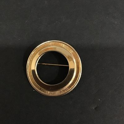 Gold tone circular brooch