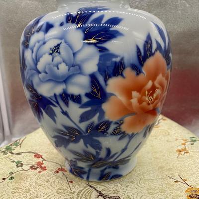 Sale Photo Thumbnail #170: Beautiful Fukugawa vase in indigo, coral and soft white colors with gilding
Peony represents prosperity, beauty and peace.
Retails at $255
6 inches x 8 inches tall 
excellent condition