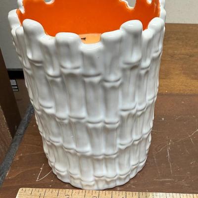 Sale Photo Thumbnail #494: Real orange color wax candles inside white ceramic bamboo-themed holders.  Approx. 6.5" tall x 4.5" across. Scented candles with a Guava fragrance.