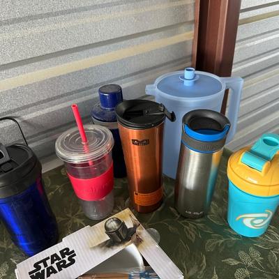 AN ARRAY OF TRAVEL CUPS, DRINKING GLASSES AND MORE