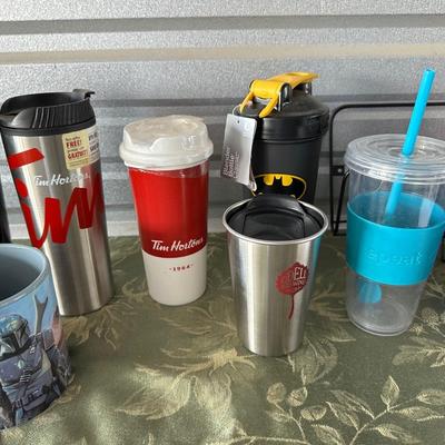 AN ARRAY OF TRAVEL CUPS, DRINKING GLASSES AND MORE