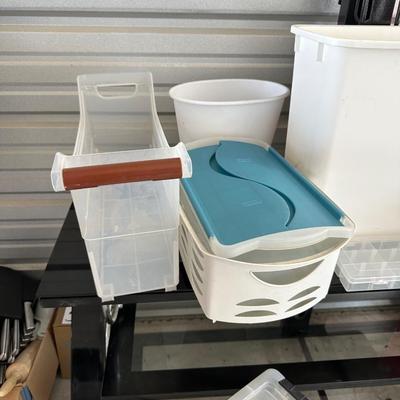 AN ASSORTMENT OF CONTAINERS, HANGERS AND A ROLL OF PLASTIC WRAP