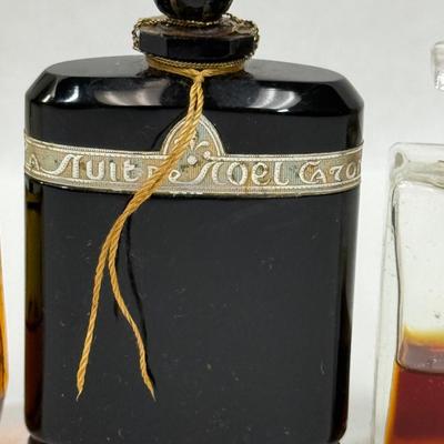 Sale Photo Thumbnail #142: Amber glass with gold top is AVON TIMELESS COLOGNE
Black glass bottle is CARON'S NUIT DE NOEL PERFUME
Clear glass is CHANNEL NO. 5PERFUME

They have about 1/2 of the perfume left inside.