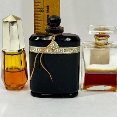 Sale Photo Thumbnail #145: Amber glass with gold top is AVON TIMELESS COLOGNE
Black glass bottle is CARON'S NUIT DE NOEL PERFUME
Clear glass is CHANNEL NO. 5PERFUME

They have about 1/2 of the perfume left inside.