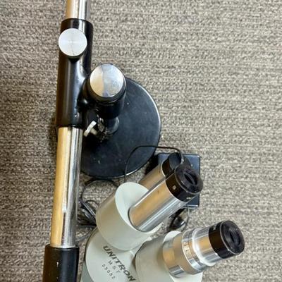 Sale Photo Thumbnail #196: Includes microscope, adjustable no-vibrate weighted stand, and variable brightness light. Tested, light works and microscope appears to be in working condition.