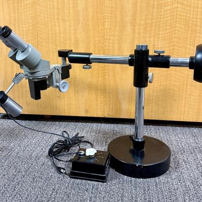 Sale Photo Thumbnail #195: Includes microscope, adjustable no-vibrate weighted stand, and variable brightness light. Tested, light works and microscope appears to be in working condition.