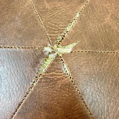 Sale Photo Thumbnail #177: Covered in brown leather, some loose stitching in the top center (see photos).