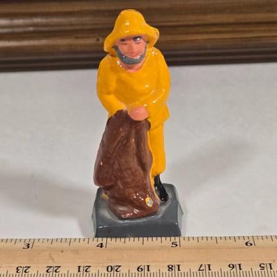 LOT 81L: Signed Seascape Oil Painting by Carson, Coasters, Salt & Pepper Shakers, Cast Iron Fisherman , and Lighthouse Print