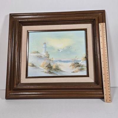 LOT 81L: Signed Seascape Oil Painting by Carson, Coasters, Salt & Pepper Shakers, Cast Iron Fisherman , and Lighthouse Print