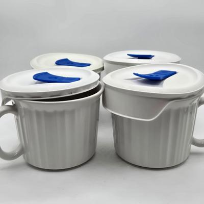LOT 197L: CorningWare French White 20 oz. Meal Mugs with Vented Lids, 16 oz. Round Ramekins with Vented Lids, and Cornflower Blue Pattern...