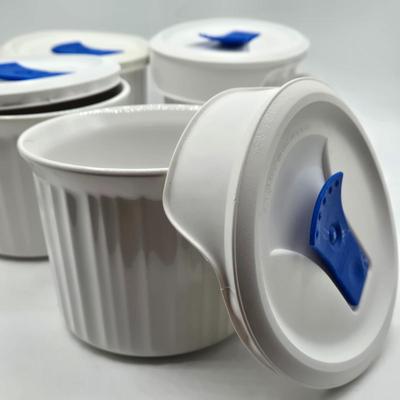 LOT 197L: CorningWare French White 20 oz. Meal Mugs with Vented Lids, 16 oz. Round Ramekins with Vented Lids, and Cornflower Blue Pattern...
