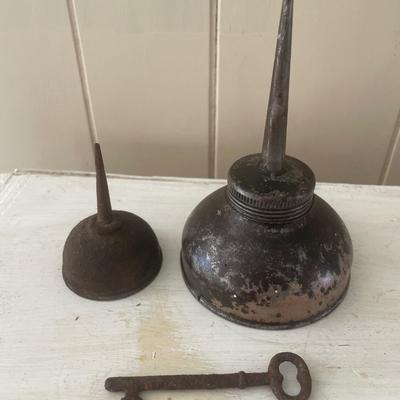 Vintage oil cans and key