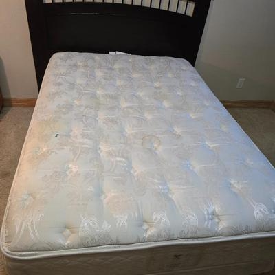 Full sized bed with wooden Purdue headboard with mattress and boxsprings and bedding