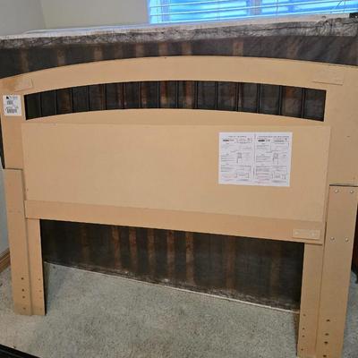 Full sized bed with wooden Purdue headboard with mattress and boxsprings and bedding