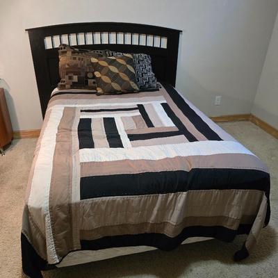 Full sized bed with wooden Purdue headboard with mattress and boxsprings and bedding