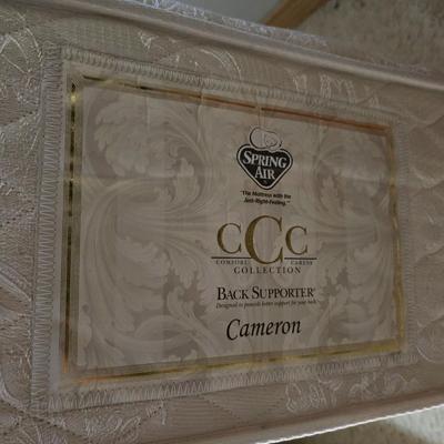 Full sized bed with wooden Purdue headboard with mattress and boxsprings and bedding