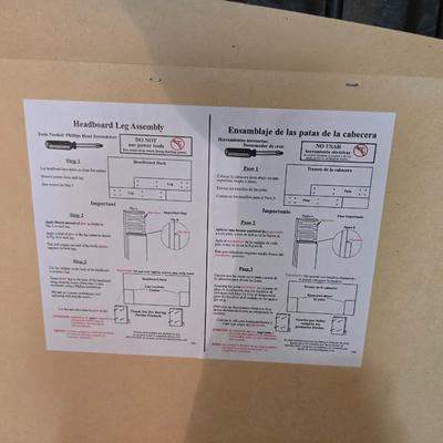 Full sized bed with wooden Purdue headboard with mattress and boxsprings and bedding