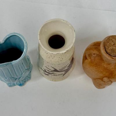 Sale Photo Thumbnail #576: San Juan Capistrano souvenir vase with small chips on top edge
Powder Blue vase with cracks and chip on top
Reddish Brown urn with stopper has no damage