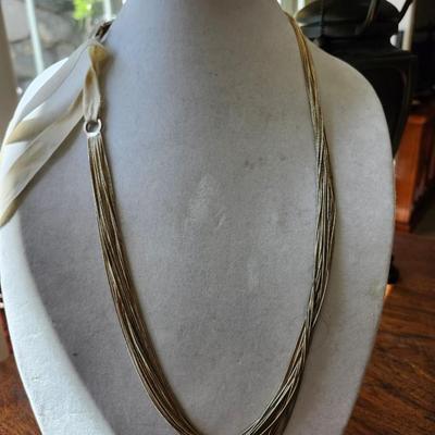 Sale Photo Thumbnail #253: Similar to and feels like liquid silver, ribbon tie off.  19 strands of chain 28 inches long.
