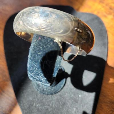 Sale Photo Thumbnail #257: Engraved, safety chain, snap closure.  2.5 inch diameter through the cuff.  1/2 inch wide