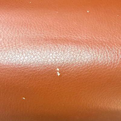 Sale Photo Thumbnail #598: Recliner chair and matching ottoman.  Good overall condition, some tiny spots in a few places on the material, not noticeable from a distance. Product details:
Color: Caramel Brown
Item dimensions (L x W x H): 42 x 30 x 40 inches
Material: Faux Leather, W
