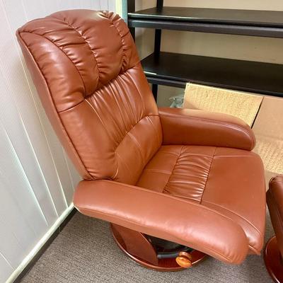 Sale Photo Thumbnail #596: Recliner chair and matching ottoman.  Good overall condition, some tiny spots in a few places on the material, not noticeable from a distance. Product details:
Color: Caramel Brown
Item dimensions (L x W x H): 42 x 30 x 40 inches
Material: Faux Leather, W