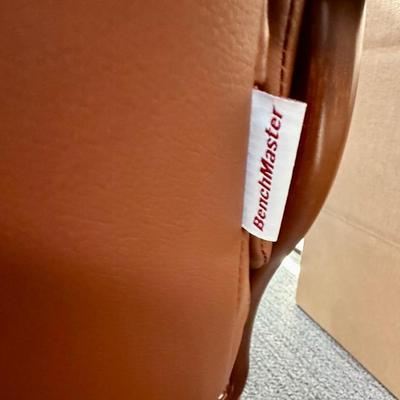 Sale Photo Thumbnail #588: Recliner chair and matching ottoman.  Good overall condition, some tiny spots in a few places on the material, not noticeable from a distance. Product details:
Color: Caramel Brown
Item dimensions (L x W x H): 42 x 30 x 40 inches
Material: Faux Leather, W